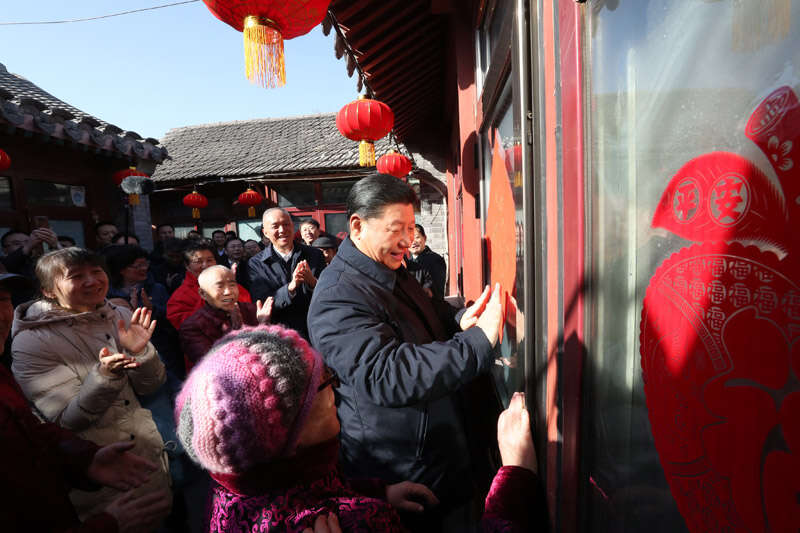 2019年2月1日上午，習近平在北京前門東區草廠四條胡同32號院，高興地拿起一幅“?！弊郑H自貼到門上，給這里的老街坊們拜年。新華社記者 鞠鵬 攝